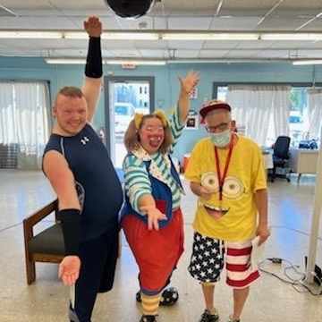 Matt and Hank striking pose with circus clown 
