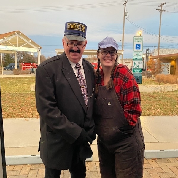Dawn and Jeff dressed up as train conductors for Polar Express themed Christmas float
