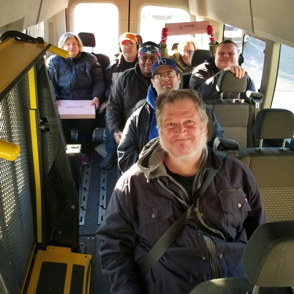 COF service recipients om a bus with yummy crumble cookies
